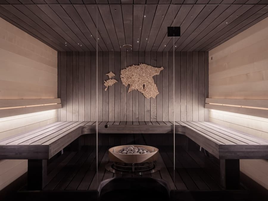 Indoor traditional wood sauna with stone heater (illustrative)