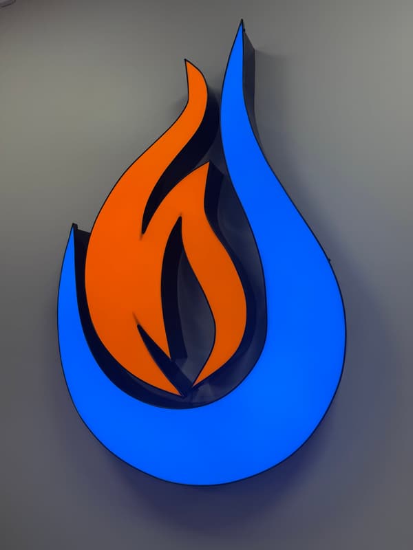 Nordic Nirvana backlit wall logo with orange flame inside a blue water drop