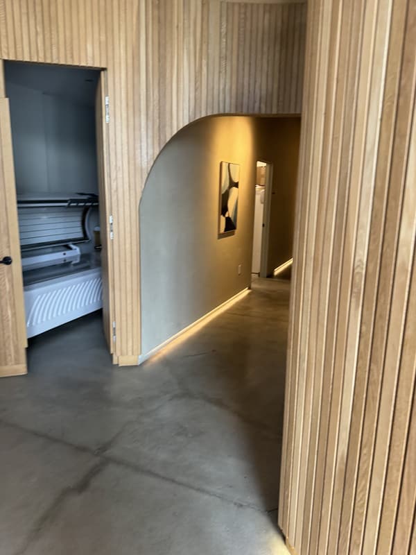 Wood-slat hallway and open private infrared suite at Pause West Hollywood
